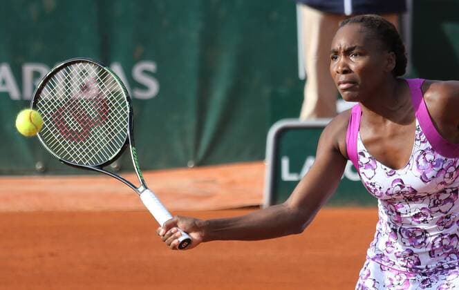 American Venus Williams hits a shot during her French Open women s first round match against American Sloane Stephens at Roland Garros in Paris on May 25, 2015. Stephens defeated Williams 7-6 (5), 6-1 to advance to the next round.  PAR20150525703 DAVIDxSILPA