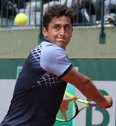 Nicolas Almagro of Spain hits a shot during his French Open men s first round match against Alexandr Dolgopolov of Ukraine at Roland Garros in Paris on May 26, 2015. Almagro defeated Dolgopolov 6-3, 2-6, 6-4, 7-6 (6) to advance to the second round.  PAR20150526720 DAVIDxSILPA