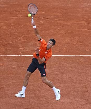 Novak Djokovic of Serbia hits a smash during his French Open men s first round match against Jarkko Nieminen of Finland at Roland Garros in Paris on May 26, 2015. Djokovic defeated Nieminen 6-2, 7-5, 6-2 to advance to the second round.  PAR20150526728 DAVIDxSILPA