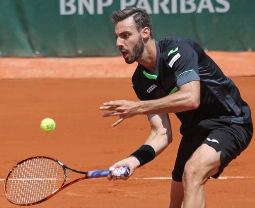 Marcel Granollers of Spain hits a shot during his French Open men s second round match against Roger Federer of Switzerland at Roland Garros in Paris on May 27, 2015. Federer defeated Granollers 6-2, 7-6 (1), 6-3 to advance to the next round.  PAR20150527713 DAVIDxSILPA