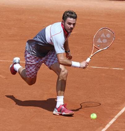 Stan Wawrinka of Switzerland hits a shot during his French Open men s second round match against Dusan Lajovic of Serbia and Montenegro at Roland Garros in Paris on May 27, 2015. Wawrinka defeated Lajovic 6-3, 6-4, 5-7, 6-3 to advance to the next round.  PAR20150527723 DAVIDxSILPA