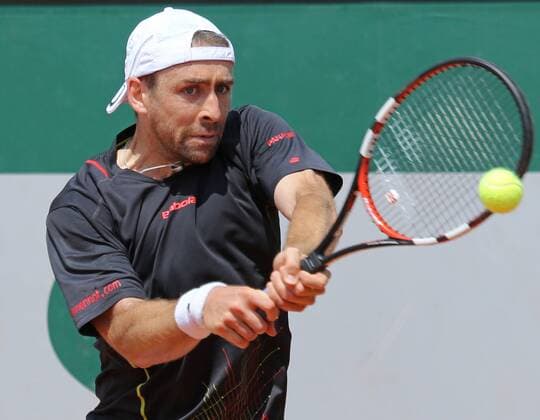 Benjamin Becker of Germany hits a shot during his French Open men s second round match against Fernando Verdasco of Spain at Roland Garros in Paris on May 27, 2015. Becker defeated Verdasco 6-4, 0-6, 1-6, 7-5, 10-8 to advance to the next round.  PAR20150527750 DAVIDxSILPA