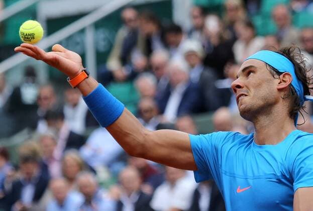 Rafael Nadal of Spain hits a serve during his French Open men s second round match against Nicolas Almagro of Spain at Roland Garros in Paris on May 28, 2015. Nadal defeated Almagro 6-4, 6-3, 6-1 to advance to the next round.  PAR20150528706 DAVIDxSILPA