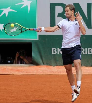 Richard Gasquet of France hits a shot during his French Open men s second round match against Carlos Berlocq of Argentina at Roland Garros in Paris on May 29, 2015. Gasquet defeated Berlocq 3-6, 6-3, 6-1, 4-6, 6-1 to advance to the next round.  PAR20150529716 DAVIDxSILPA