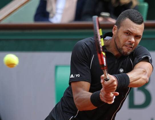 Jo-Wilfried Tsonga of France hits a shot during his French Open men s fourth round match against Tomas Berdych of the Czech Republic at Roland Garros in Paris on May 31, 2015. Tsonga defeated Berdych 6-3, 6-2, 6-7 (5), 6-3 to advance to the next round.  PAR20150531729 DAVIDxSILPA