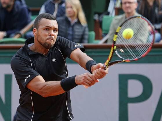 Jo-Wilfried Tsonga of France hits a shot during his French Open men s fourth round match against Tomas Berdych of the Czech Republic at Roland Garros in Paris on May 31, 2015. Tsonga defeated Berdych 6-3, 6-2, 6-7 (5), 6-3 to advance to the next round.  PAR20150531738 DAVIDxSILPA