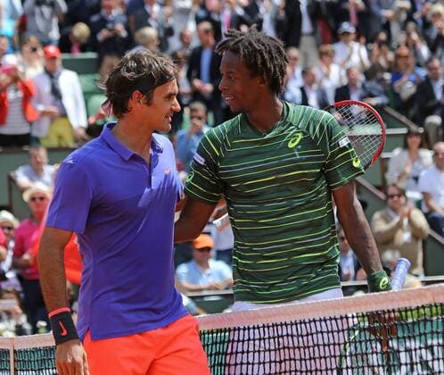 Roger Federer of Switzerland (L) meets Gael Monfils of France at the net after winning their French Open men s fourth round match at Roland Garros in Paris on June 1, 2015. Federer defeated Monfils 6-3, 4-6, 6-4, 6-1 to advance to the next round.  PAR20150601734 DAVIDxSILPA
