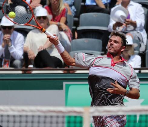 Stan Wawrinka of Switzerland hits a shot during his French Open men s semifinal match against Jo-Wilfried Tsonga of France at Roland Garros in Paris on June 5, 2015.  PAR20150605706 DAVIDxSILPA