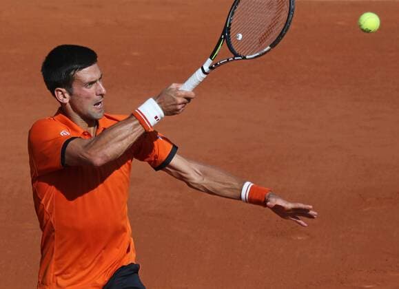 Novak Djokovic of Serbia hits a shot during his French Open men s semifinal match against Andy Murray of Great Britain at Roland Garros in Paris on June 5, 2015.  PAR20150605738 DAVIDxSILPA
