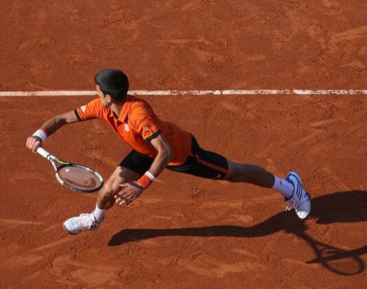 Novak Djokovic of Serbia hits a shot during his French Open men s semifinal match against Andy Murray of Great Britain at Roland Garros in Paris on June 5, 2015.  PAR20150605746 DAVIDxSILPA
