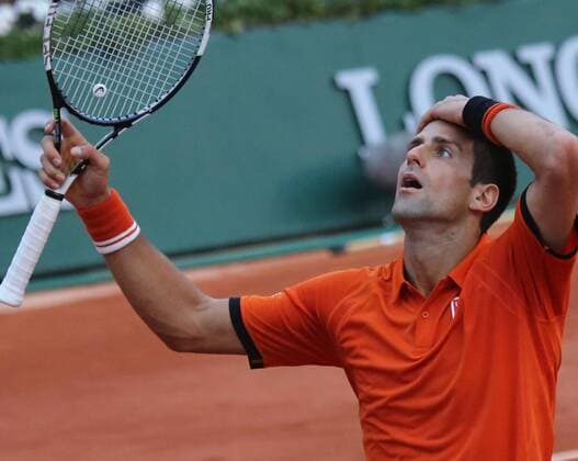 Novak Djokovic of Serbia reacts after a shot during his French Open men s semifinal match against Andy Murray of Great Britain at Roland Garros in Paris on June 5, 2015. Play was suspended due to rain and darkness with Djokovic leading 6-3, 6-3, 5-7, 3-3.  PAR20150605760 DAVIDxSILPA