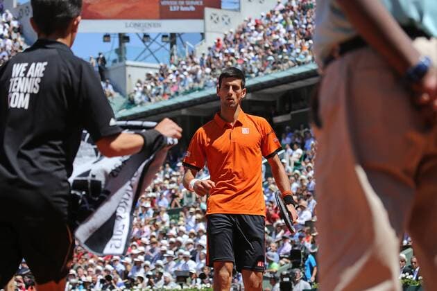 Novak Djokovic of Serbia pauses during his French Open men s semifinal match against Andy Murray of Great Britain at Roland Garros in Paris on June 6, 2015. Djokovic defeated Murray 6-3, 6-3, 5-7, 5-7, 6-1.  PAR20150606703 DAVIDxSILPA