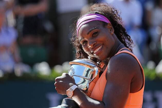 American Serena Williams holds the championship trophy after winning her French Open women s final match against Lucie Safarova of the Czech Republic at Roland Garros in Paris on June 6, 2015. Williams defeated Safarova 6-3, 6-7 (2), 6-2 to win her third French Open title.  PAR20150606723 DAVIDxSILPA