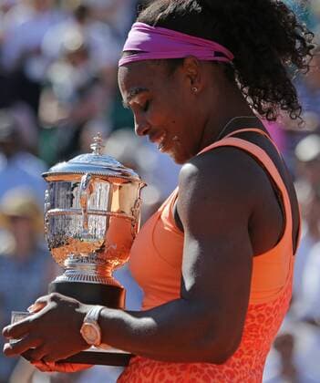 American Serena Williams holds the championship trophy after winning her French Open women s final match against Lucie Safarova of the Czech Republic at Roland Garros in Paris on June 6, 2015. Williams defeated Safarova 6-3, 6-7 (2), 6-2 to win her third French Open title.  PAR20150606733 DAVIDxSILPA