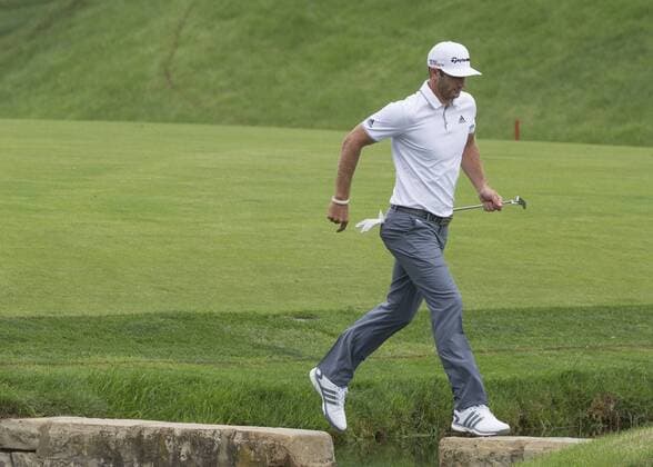 June 06 2015: Dustin Johnson jumping over a small creak on hole 14 during the third round of the Memorial Tournament held at the Muirfield Village Golf Club in Dublin, Ohio. GOLF: JUN 06 PGA Golf Herren - the Memorial Tournament - Third Round Icon150606036 EDITORIAL USE ONLY