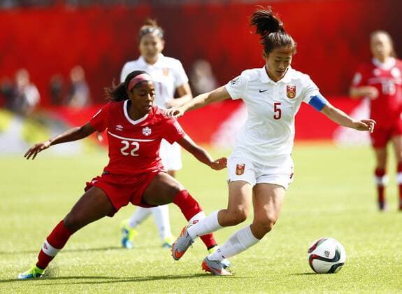 China s Wu Haiyan (R) vies for the ball with Canada s Ashley Lawrence during the opening match between China and Canada at the 2015 FIFA Women s World Cup at Commonwealth Stadium in Edmonton, Canada, June 6, 2015. ) (SP)CANADA-EDMONTON-FIFA WOMEN S WORLD CUP-OPENING MATCH-CAN VS CHN DingxXu 
