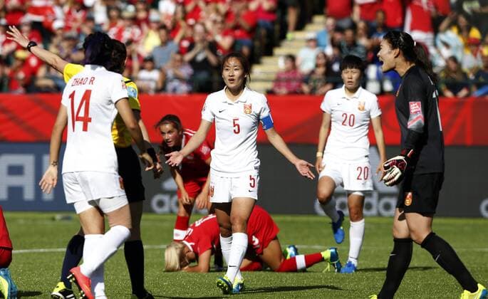 China s captain Wu Haiyan (C) and goalie Wang Fei (1st R) react after referee Kateryna Monzul of Ukraine gave a penalty kick to Canada during the opening match between China and Canada at the 2015 FIFA Women s World Cup finals in the Commonwealth Stadium in Edmonton, Canada, on June 6, 2015. China lost 0-1. ) (SP)CANADA-EDMONTON-FIFA WOMEN S WORLD CUP-GROUP A-CHN VS CAN WangxLili 