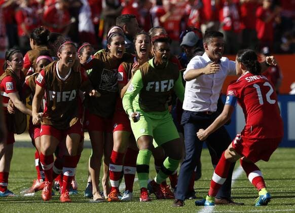 Canada s Christine Sinclair (1st R) celebrates scoring with head coach Jone Herdman (2nd R) during a Group A match between China and Canada at the 2015 FIFA Women s World Cup finals in the Commonwealth Stadium in Edmonton, Canada, June 6, 2015. China lost 0-1. ) (SP)CANADA-EDMONTON-FIFA WOMEN S WORLD CUP-GROUP A-CHN VS CAN WangxLili 