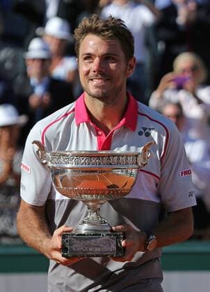 Stan Wawrinka of Switzerland holds the championship trophy after winning his French Open men s final match against Novak Djokovic of Serbia at Roland Garros in Paris on June 7, 2015. Wawrinka defeated Djokovic 4-6, 6-4, 6-3, 6-4 to win his first French Open championship.  PAR20150607710 DAVIDxSILPA
