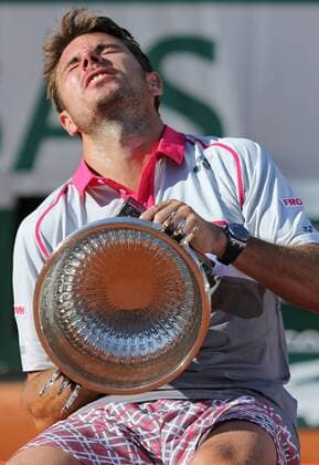 Stan Wawrinka of Switzerland holds the championship trophy after winning his French Open men s final match against Novak Djokovic of Serbia at Roland Garros in Paris on June 7, 2015. Wawrinka defeated Djokovic 4-6, 6-4, 6-3, 6-4 to win his first French Open championship.  PAR20150607716 DAVIDxSILPA