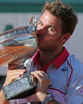 Stan Wawrinka of Switzerland holds the championship trophy after winning his French Open men s final match against Novak Djokovic of Serbia at Roland Garros in Paris on June 7, 2015. Wawrinka defeated Djokovic 4-6, 6-4, 6-3, 6-4 to win his first French Open championship.  PAR20150607720 DAVIDxSILPA