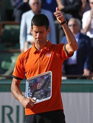 Novak Djokovic of Serbia holds the runners-up trophy after losing his French Open men s final match against Stan Wawrinka of Switzerland at Roland Garros in Paris on June 7, 2015. Wawrinka defeated Djokovic 4-6, 6-4, 6-3, 6-4 to win his first French Open championship.  PAR20150607725 DAVIDxSILPA