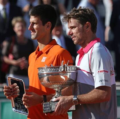 Stan Wawrinka (R) of Switzerland and Novak Djokovic of Serbia hold their trophies after winning their French Open men s final match at Roland Garros in Paris on June 7, 2015. Wawrinka defeated Djokovic 4-6, 6-4, 6-3, 6-4 to win his first French Open championship.  PAR20150607726 DAVIDxSILPA