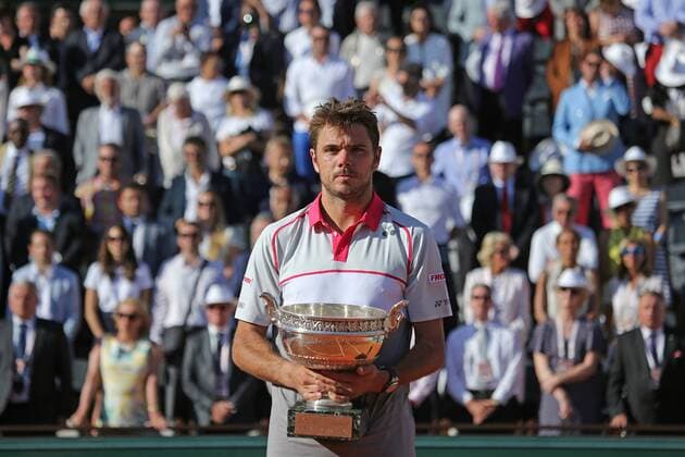 Stan Wawrinka of Switzerland holds the championship trophy after winning his French Open men s final match against Novak Djokovic of Serbia at Roland Garros in Paris on June 7, 2015. Wawrinka defeated Djokovic 4-6, 6-4, 6-3, 6-4 to win his first French Open championship.  PAR20150607742 DAVIDxSILPA