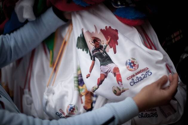 A woman sells promotional items related to the Copa America 2015, in a street in downtown Santiago city, capital of Chile, on June 9, 2015. Santiago will be one of the host cities of the Copa America Chile 2015. (da) (SP)CHILE-SANTIAGO-COPA AMERICA-DAILY LIFE e PedroxMera 