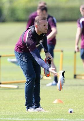 England s Wayne Rooney replaces his boots during training England Training & press conference PK Pressekonferenz Watford Training Ground - England - 11th June 2015 - Picture David Klein Sportimage EDITORIAL USE ONLY. No use with unauthorised audio, video, data, fixture lists, club league logos or live services. Online in-match use limited to 120 images, no video emulation. No use in betting, games or single club league player publications.