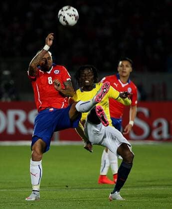 SANTIAGO, June 11, 2015 -- Arturo Vidal (L) of Chile vies for the ball with Juan Paredes (R) from Ecuador, during the opening match of the Copa America 2015, in Santiago, capital of Chile, on June 11, 2015. Chile won 1-0. 