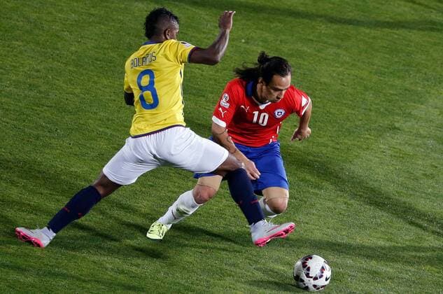SANTIAGO, June 11, 2015 -- Jorge Valdivia (R) of Chile vies for the ball with Miller Bolanos (L) from Ecuador during the opening match of the Copa America 2015, in Santiago, capital of Chile, on June 11, 2015. Chile won 1-0. 