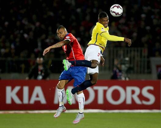 SANTIAGO, June 11, 2015 -- Arturo Vidal (L) of Chile vies for the ball with Gabriel Achilier (R) from Ecuador during the opening match of the Copa America 2015, in Santiago, capital of Chile, on June 11, 2015. Chile won 1-0. 