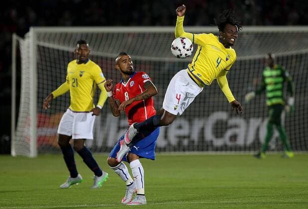 SANTIAGO, June 11, 2015 -- Arturo Vidal (C) of Chile vies for the ball with Juan Paredes (R) from Ecuador during the opening match of the Copa America 2015, in Santiago, capital of Chile, on June 11, 2015. Chile won 1-0. 