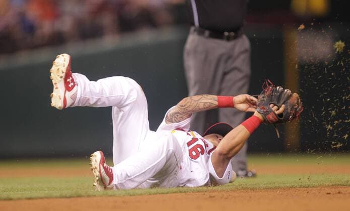 St. Louis Cardinals Kolten Wong knocks down a line drive off the bat of Kansas City Royals Lorenzo Cain in the sixth inning at Busch Stadium in St. Louis on June 12, 2015. The hit was good for a single.  SLP2015061207 BILLxGREENBLATT