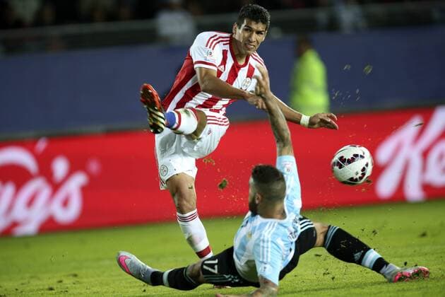 (150614) -- LA SERENA, June 14, 2015 -- Argentina s Nicolas Otamendi (Bottom) defends Marcos Caceres of Paraguay during their Group B match against Paraguay at Copa America 2015, in La Serena, Chile, on June 13, 2015. The match ended with a 2-2 draw. ) (SP)CHILE-LA SERENA-COPA AMERICA-ARGENTINA VS PARAGUAY AGENCIAxUNO 