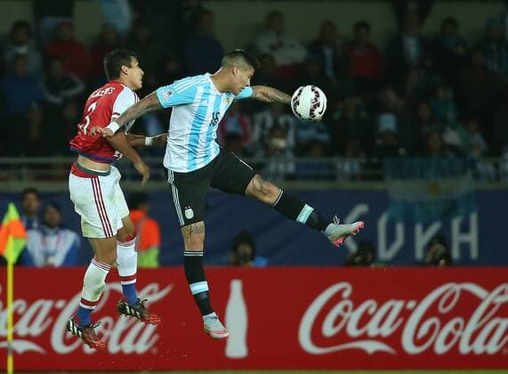 (150614) -- LA SERENA, June 14, 2015 -- Marcos Rojo (R) of Argentina fights for the ball with Marcos Caceres of Paraguay during their Group B match agaisnt Paraguay at Copa America 2015, in La Serena, Chile, on June 13, 2015. The match ended with a 2-2 draw. ) (SP)CHILE-LA SERENA-COPA AMERICA-ARGENTINA VS PARAGUAY XuxZijian 