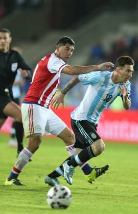(150614) -- LA SERENA, June 14, 2015 -- Argentina s Lionel Messi (R) vies with a player of Paraguay during their Group B match at Copa America 2015, in La Serena, Chile, on June 13, 2015. The match ended with a 2-2 draw. ) (SP)CHILE-LA SERENA-COPA AMERICA-ARGENTINA VS PARAGUAY RongxHao 