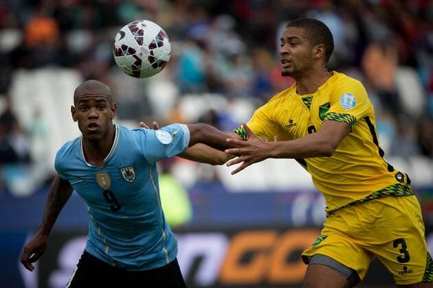 (150614) -- ANTOFAGASTA, June 14, 2015 -- Diego Rolan (L) of Uruguay vies with Michael Hector of Jamaica during a Group B match at Copa America 2015, in Antofagasta, Chile, on June 13, 2015. Uruguay won 1-0. ) (SP)CHILE-ANTOFAGASTA-COPA AMERICA-GROUP B-URUGUAY VS JAMAICA PedroxMera 