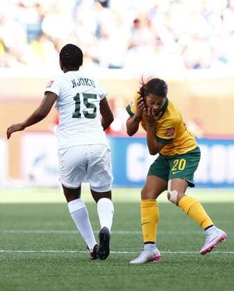 (150615) -- WINNIPEG, June 15, 2015 -- Photo taken on June 12, 2015 shows Samantha Kerr (R) of Australia reacting after being elbowed in the face by Nigeria s Ugo Njoku (L) during the Group D match between Australia and Nigeria in Winnipeg, Canada. (SP)CANADA-WINNIPEG-FIFA WOMEN S WORLD CUP-NIGERIA-UGO NJOKU-BAN DingxXu 