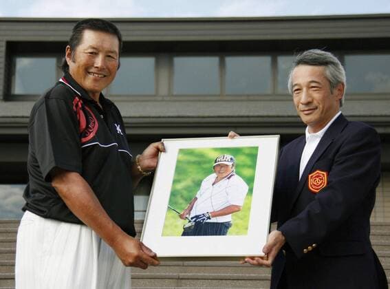 YOKOHAMA, Japan - Masashi Jumbo Ozaki (L), the JGTO Tour leader with 94 career wins, receives a panel as an inductee into the World Golf Hall of Fame at the Totsuka Country Club in Yokohama on Oct. 7, 2010.  1007035