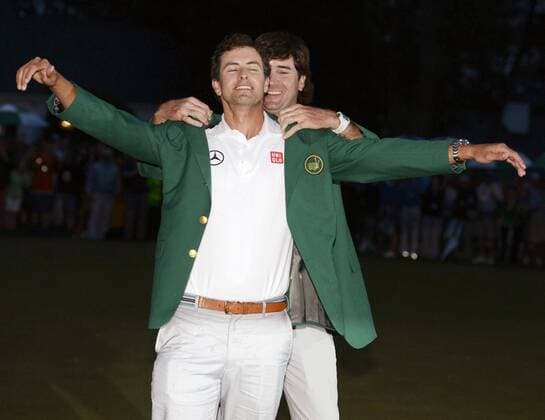 AUGUSTA, United States - Adam Scott (front) of Australia has a green jacket put on by Bubba Watson (back) of the United States, the winner of the 2012 Masters Tournament, after winning his first major title at the 2013 tournament at Augusta National Golf Club in Augusta, Georgia, on April 14, 2013.  0415032