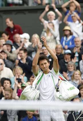 LONDON, United Kingdom - Sergiy Stakhovsky of Ukraine acknowledges cheers from spectators after defeating Roger Federer of Switzerland in a second-round men s singles match at the Wimbledon Championships at the All England Club in Wimbledon, southwest London, on June 26, 2013. Stakhovsky won 6-7(5), 7-6(5), 7-5, 7-6(5).  0627061