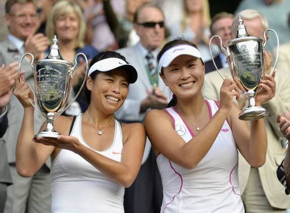 LONDON, United Kingdom - Hsieh Su-wei (L) of Taiwan and Peng Shuai of China hold the winner s trophies after their victory in the women doubles final Ashleigh Barty and Casey Dellacqua of Australia at the Wimbledon Championships at the All England Club in Wimbledon, southwest London, on July 6, 2013. The Hsieh-Peng pair won the title 7-6(1), 6-1.  0708021