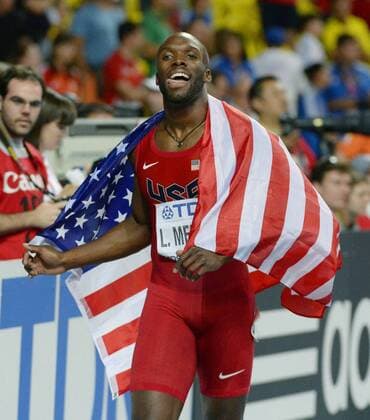 MOSCOW, Russia - LaShawn Merritt of the United States celebrates with the U.S. national flag after winning the men s 400 meters with a time of 43.74 seconds at the world athletics championships in Moscow on Aug. 13, 2013.  0814026