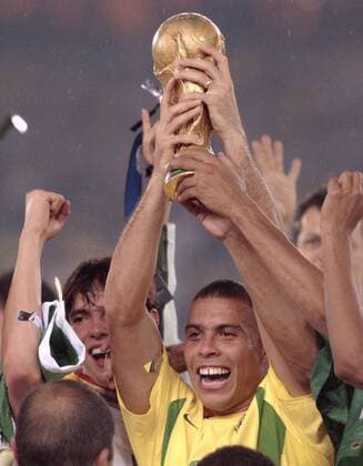 TOKYO, Japan - Former Brazilian striker Ronaldo (C) lifts the 2002 World Cup trophy after his team beat Germany 2-0 in the final in Yokohama, southwest of Tokyo, on June 30, 2002. The 34-year-old announced his retirement from professional football Feb. 14, 2011, due to weight control problems stemming from a thyroid disease.  0215001