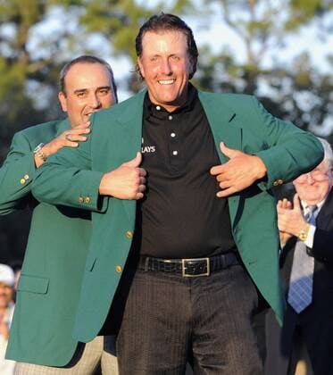 AUGUSTA, United States - Phil Mickelson of the United States (L) receives the green jacket from Angel Cabrera of Argentina after winning the Masters golf tournament at the Augusta National Golf Club in Augusta, Georgia, on April 11, 2010. Mickelson fired a final-round 67 to finish on 16 under par, three shots clear of Britain s Lee Westwood, and clinch a fourth major championship.  0412003