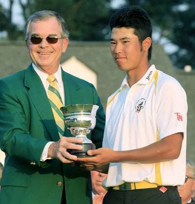 AUGUSTA, United States - Japan s Hideki Matsuyama (R) receives the Silver Cup for the amateur golfer with the best score after finishing 27th in the Masters golf tournament at the Augusta National Golf Club in Georgia on April 10, 2011. Matsuyama is a student at Tohoku Fukushi University in the quake-hit city of Sendai.  0411062