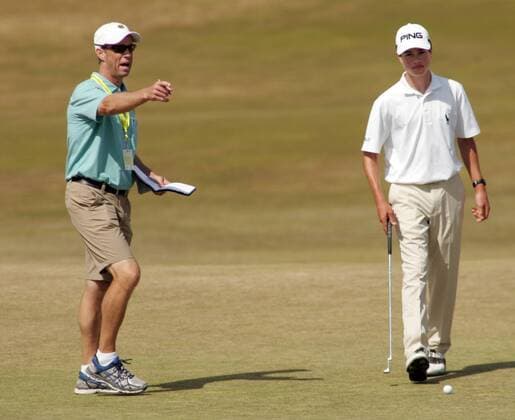 15-year-old Cole Hammer, from Houston, right, receives some points from his father, Gregg, during a practice round prior to the start of the 115th U.S. Open Championship at Chambers Bay on June 16, 2015 in University Place, Washington.  SEA20150616123 JIMxBRYANT