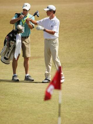 15-year-old Cole Hammer, from Houston receives his putter from his father, Gregg, during a practice round prior to the start of the 115th U.S. Open Championship at Chambers Bay on June 16, 2015 in University Place, Washington.  SEA20150616126 JIMxBRYANT